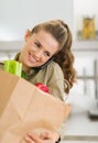 Housewife with big shopping bag talking cell phone Royalty Free Stock Photo