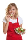 Housewife with blonde hair eating her salad Royalty Free Stock Photo