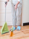 Housewife with broom and dustpan