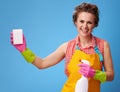 Housewife with cleaning detergent using kitchen sponge on blue Royalty Free Stock Photo