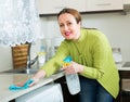 Housewife cleaning furniture in kitchen Royalty Free Stock Photo