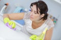 Housewife cleaning surface table with disinfectant Royalty Free Stock Photo