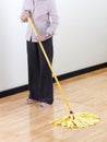 Housewife cleaning wooden floor by mop Royalty Free Stock Photo