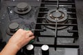 A housewife cleans the kitchen gas glass-ceramic black stove with a sponge. House cleaning Royalty Free Stock Photo