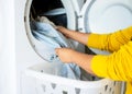 Housewife cleanup lints and dirt from tumble dryer filter. Clothes dryer lint filter that is covered with lint. Taking the lint ou