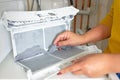 Housewife cleanup lints and dirt from tumble dryer filter. Clothes dryer lint filter that is covered with lint. Taking the lint ou Royalty Free Stock Photo