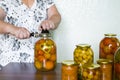 housewife closes the banks of homemade preserves