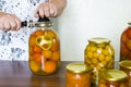 housewife closes the banks of homemade preserves