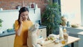 Housewife coming home with shopping bags. Young girl talking phone in kitchen. Royalty Free Stock Photo