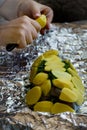 Woman is cooking salmon fish with with potatoes and and dill in foil. Royalty Free Stock Photo