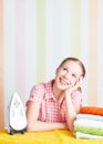 Housewife dreamy woman with iron engaged in domestic work Royalty Free Stock Photo