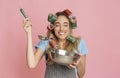 Housewife enjoys taste, holding bowl and ladle in hand Royalty Free Stock Photo