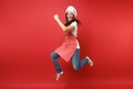 Housewife female chef cook or baker in striped apron white t-shirt, toque chefs hat isolated on red wall background