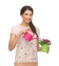 Housewife with flower in pot and watering can Royalty Free Stock Photo