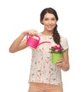 Housewife with flower in pot and watering can Royalty Free Stock Photo