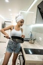 housewife with frying pan in the kitchen prerare breakfest after shower Royalty Free Stock Photo