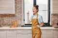 a housewife gestures with his hands kitchen apartment kitchen utensils interior household concept