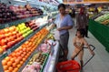 Housewife and her son shopping at one of the supermarkets in the city of Solo, Central Java Indonesia. they buy fruit and other ba