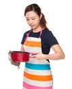 Housewife hold with skillet with oven gloves