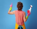 Housewife with kitchen sponge and detergent bottle pointing up Royalty Free Stock Photo