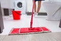 Housewife mopping the floor in a bathroom Royalty Free Stock Photo