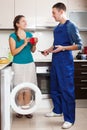 Housewife paying repairman for work Royalty Free Stock Photo