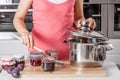 Housewife preparing plum jams Royalty Free Stock Photo