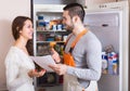 Housewife showing broken refrigerator Royalty Free Stock Photo