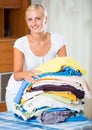 Housewife with stack of linen