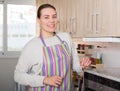 Housewife is standing and posing in the kitchen