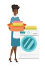 Housewife using washing machine at laundry.