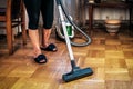 Housewife vacuuming parquet