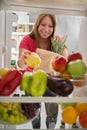 Housewife was in market place and put peppers in fridge