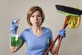 housewife in washing rubber gloves carrying cleaning spray bottle broom and mop Royalty Free Stock Photo