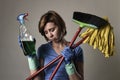 housewife in washing rubber gloves carrying cleaning spray bottle broom and mop Royalty Free Stock Photo