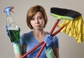 Housewife in washing rubber gloves carrying cleaning spray bottle broom and mop Royalty Free Stock Photo