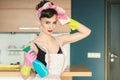 Housewife woman in retro outfit attempting to clean the kitchen Royalty Free Stock Photo