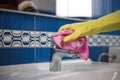 Housewife work, a housewife doing her job,cleaning her bathroom in the bathroom, gloves on her hands and a patch in her hand Royalty Free Stock Photo