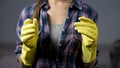 Housewife in yellow gloves ready to start cleaning household, housekeeping