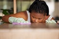 Housework, cleaning and black woman with cloth, table wash and surface at home. African American female cleaner, girl or Royalty Free Stock Photo