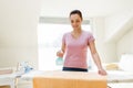 Woman or housewife ironing towel at home Royalty Free Stock Photo