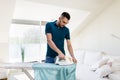 Man ironing shirt by iron at home Royalty Free Stock Photo