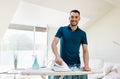 Smiling man ironing shirt by iron at home Royalty Free Stock Photo
