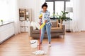 African woman or housewife cleaning floor at home Royalty Free Stock Photo