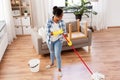 African woman or housewife cleaning floor at home Royalty Free Stock Photo