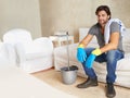 Housework is not just for women. a young man taking a break from cleaning the house. Royalty Free Stock Photo