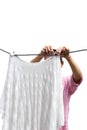 Housework woman hand hanging clean wet laundry to dry clothes is