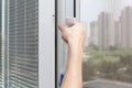 Houseworker clean plastic pvc window with detergent. Royalty Free Stock Photo