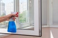 Houseworker clean plastic pvc windows with detergent. Royalty Free Stock Photo