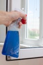 Houseworker clean plastic pvc windows with detergent. Royalty Free Stock Photo